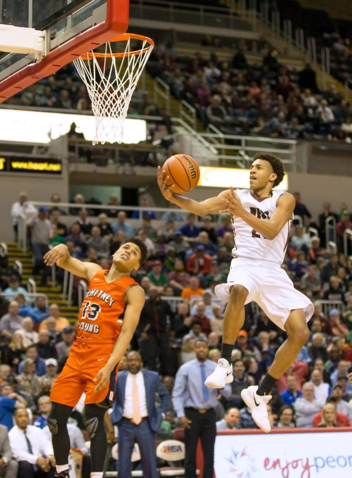 Belleville West's Curtis Williams goes up for an easy two during Saturday's IHSA Class 4A state championship game. The Maroons beat the Whitney Young Dolphins 60-56 in overtime to win their first state championship.