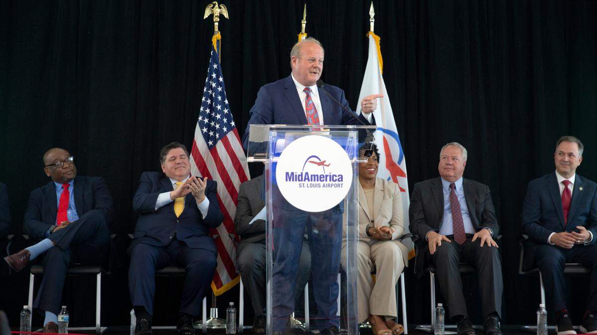 St. Clair County Board Chairman Mark Kern, center, speaks at the grand opening of a new terminal on Tuesday, June 13, 2023 at MidAmerica St. Louis Airport. Behind him sit, from left, State Sen. Christopher Belt, D-Swansea; Illinois Gov. J.B. Pritzker; Illinois Lt. Gov. Juliana Stratton; State Rep. Jay Hoffman, D-Swansea; and FAA Regional Administrator Erik Amend.