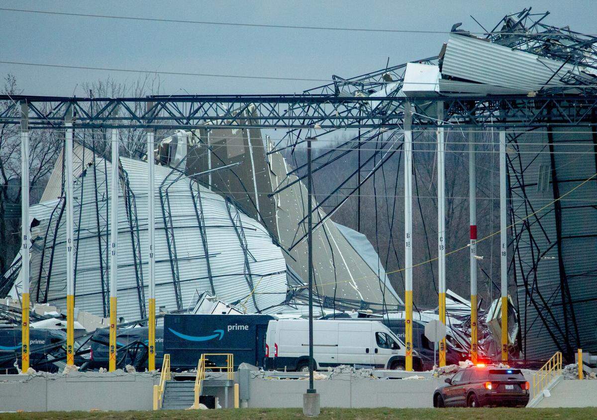 Workers attempt to clear debris from a collapsed warehouse at an Amazon facility in Edwardsville on Dec. 11. The building didn’t have a separate storm shelter, as is the case with many others in the metro-east.