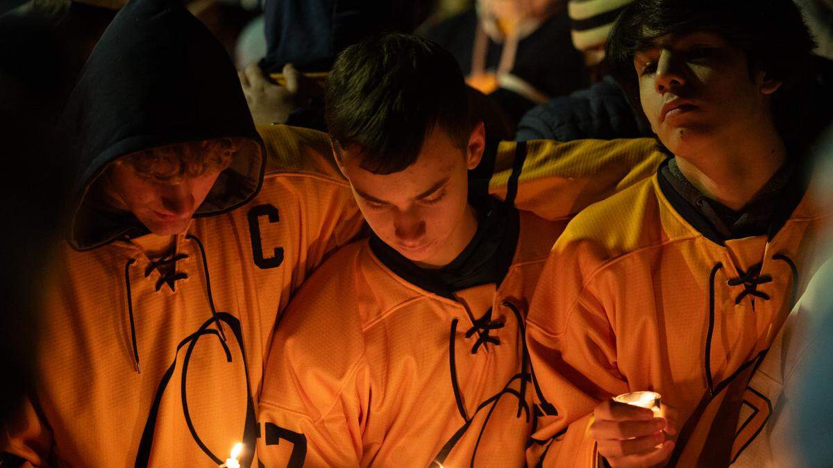 Fellow hockey players gathered in prayer during a candlelight vigil held in support of Colin Brown, 16, who was hit by a stray bullet in his car while going home to O’Fallon from a hockey game with his father. Friends gathered for the vigil at the McKendree MetroRecplex in O’Fallon Monday.