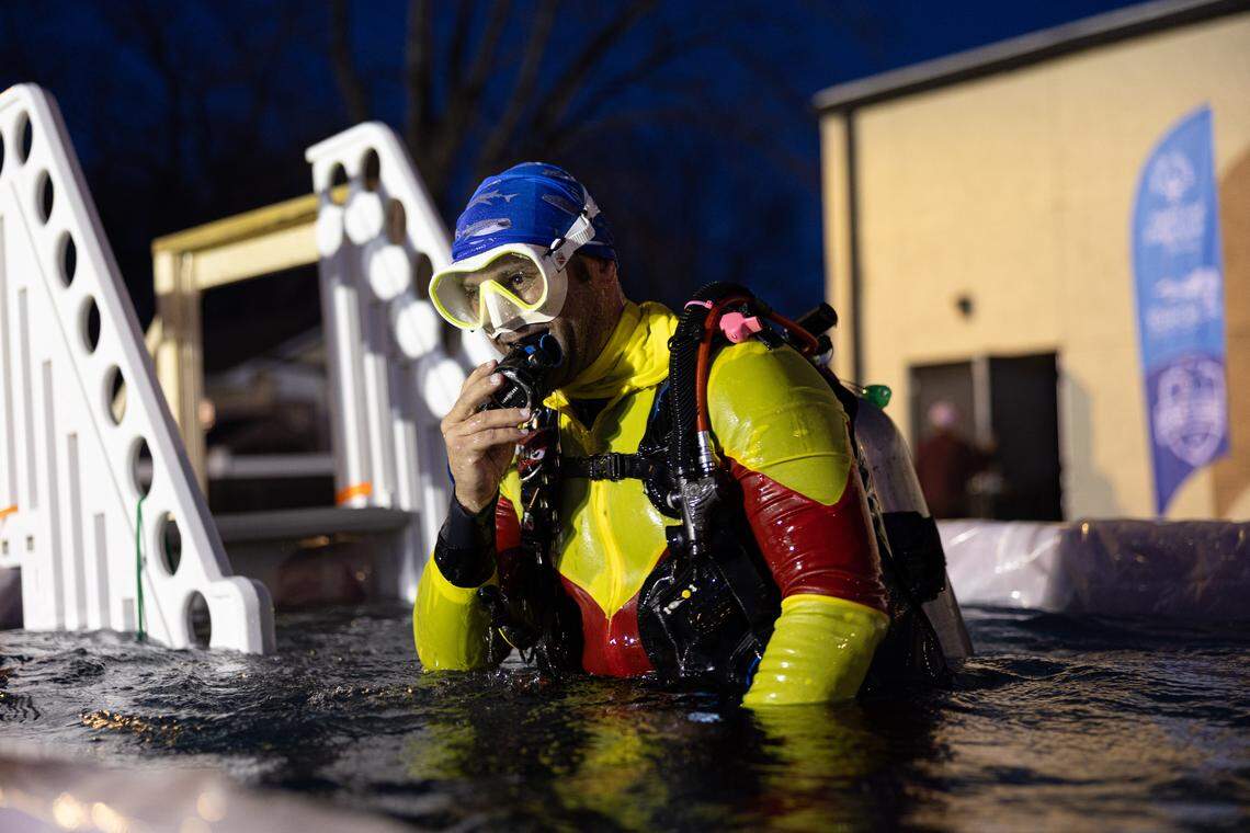 Joe Bodenbender of O’Fallon Underwater Search and Rescue fits a respirator prior to the start of the Polar Plunge in Collinsville Friday.