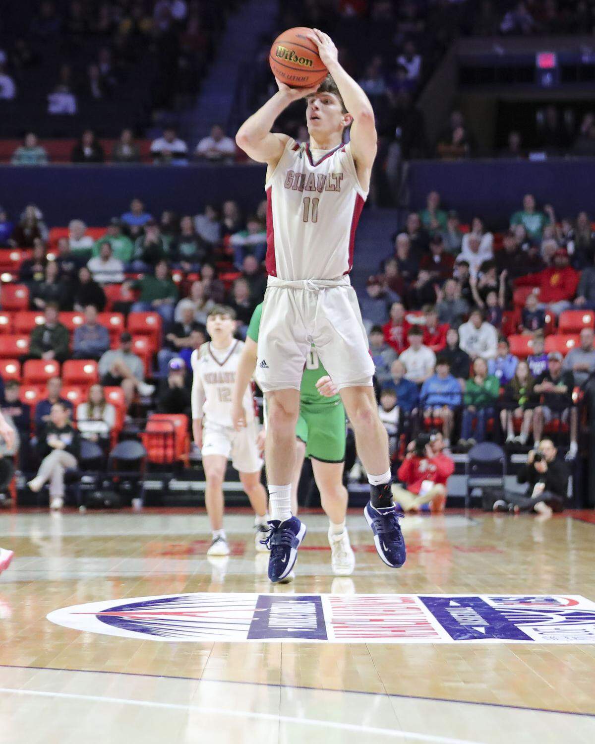 Gibault’s Hudson Blank attempts a 3-pointer during Saturday’s IHSA Class 1A state championship game against Scales Mounds at the State Farm Center on the campus of the University of Illinois. Gibault ultimately prevailed 65-45 to claim the state title.
