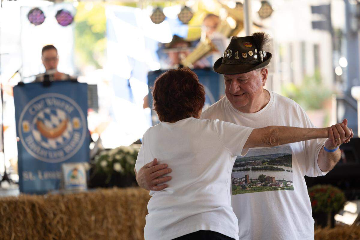 A couple dances as the Wurst Bavarian Band plays traditional German folk music in the background.