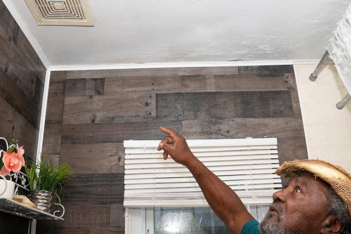 Cahokia Heights resident Lonnie Greenwood points out mold in his home. “I just feel terrible all the time,” he said.