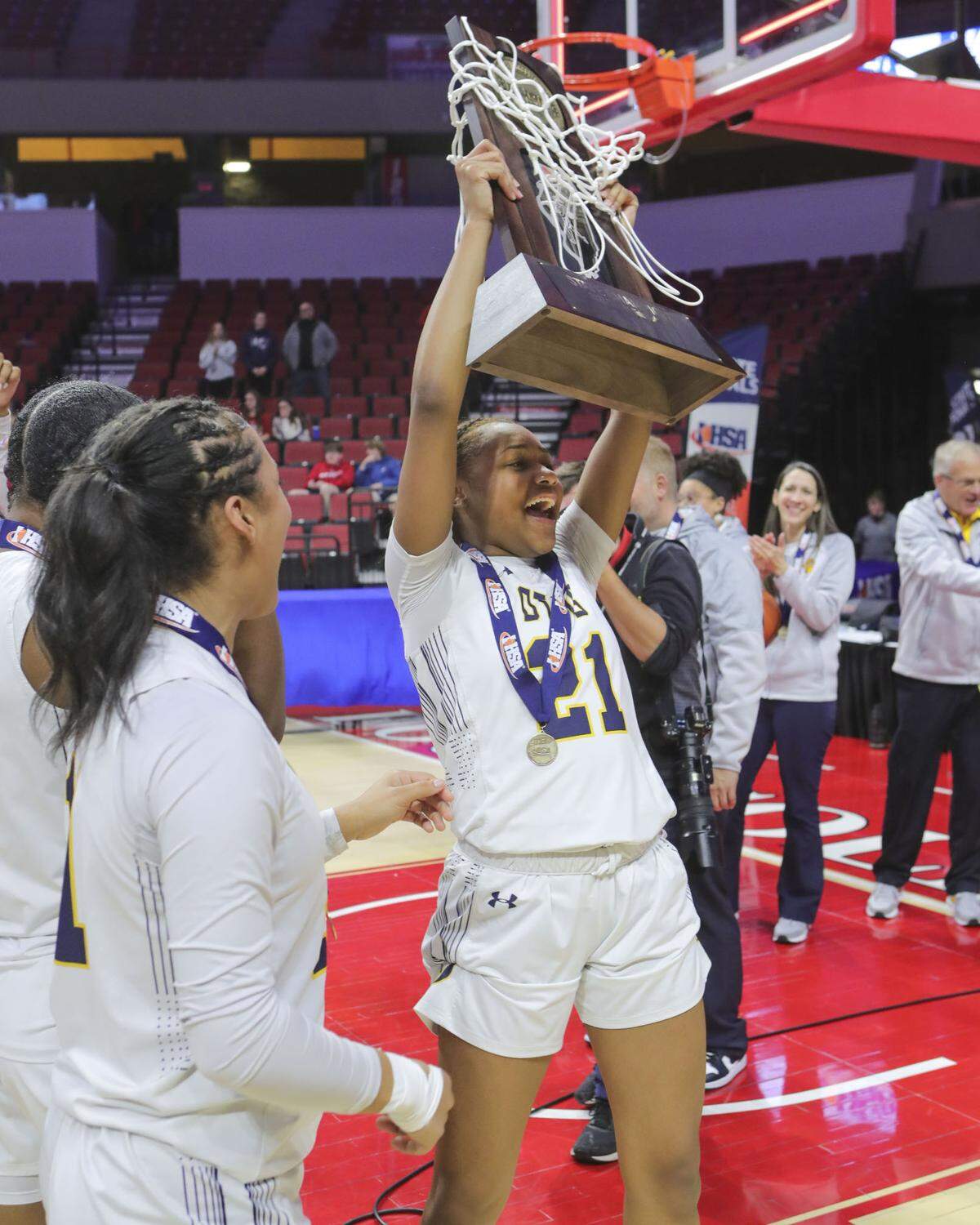 O’Fallon’s Shannon Dowel celebrates with the championship trophy after defeating Lisle Benet Academy in Saturday’s IHSA Class 4A state championship game at CEFCU Arena (formerly Redbird Arena) on the campus of Illinois State University. O’Fallon ultimately prevailed 62-57 to claim the state title.
