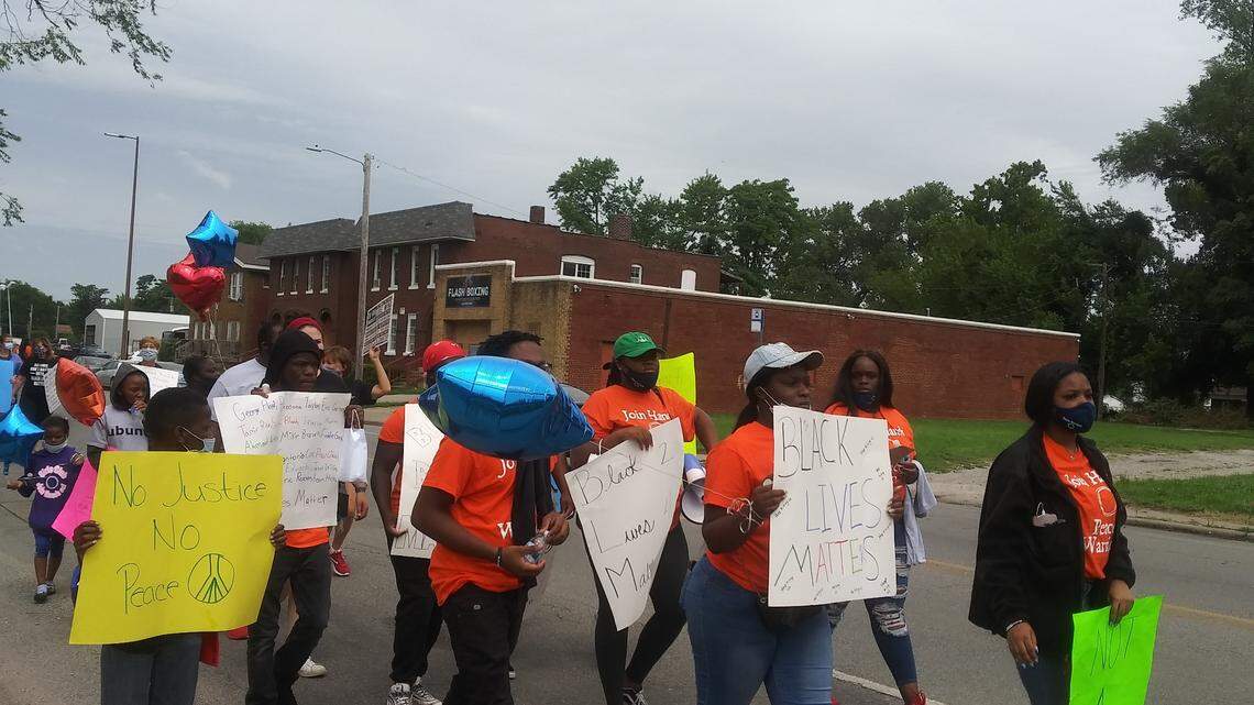Members of Join Hands Peace Warriors lead protest on State Street in East St. Louis