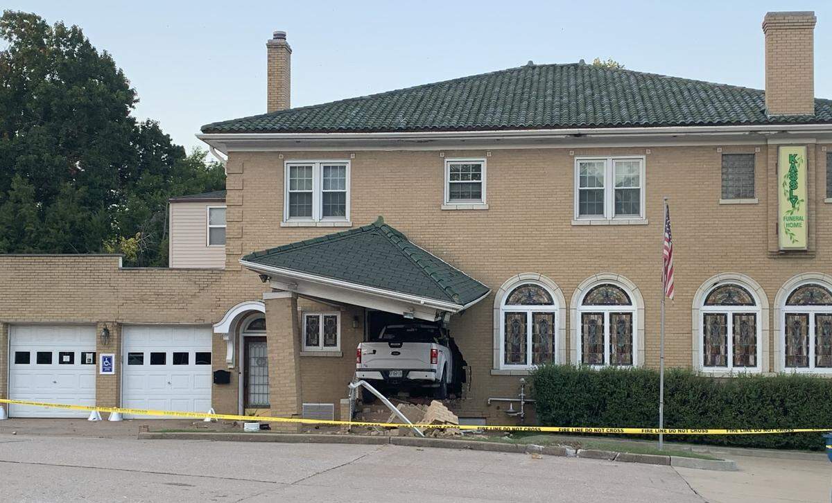 A white Ford truck that crashed into Kassly-Meridith Funeral Home in Collinsville early Sunday was still lodged in the building on Monday.