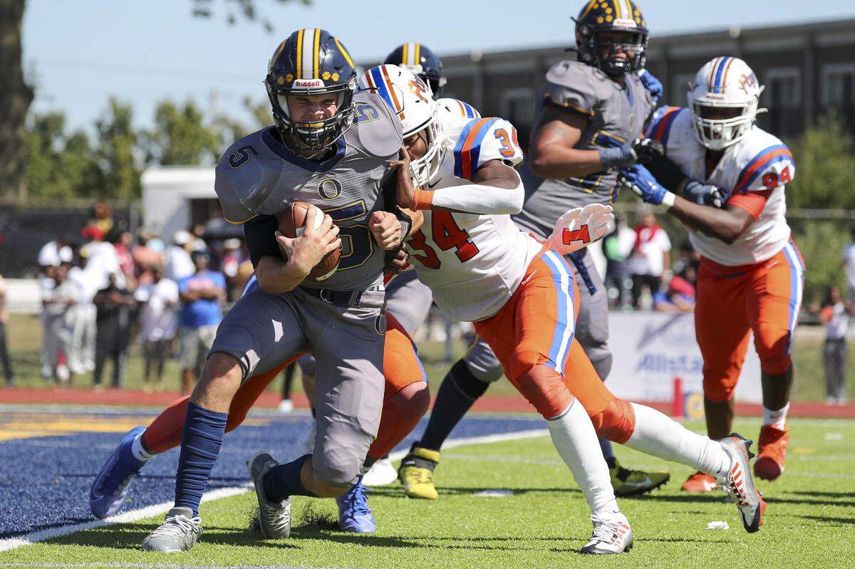 O’Fallon quarterback Colt Michael is sacked by East St. Louis linebacker Dominic Dixon during Saturday’s Southwestern Conference game. The Flyers rolled to a 60-21 victory.