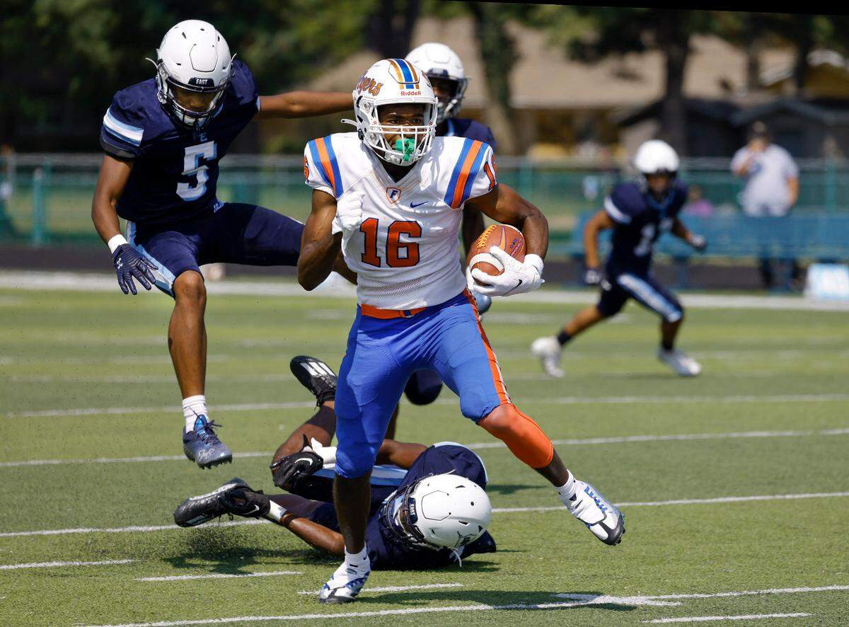 East St. Louis wide receiver Caiden Rogers runs the ball after a catch against host Belleville East during a Southwestern Conference game Saturday. The Flyers rolled to a 57-0 victory.