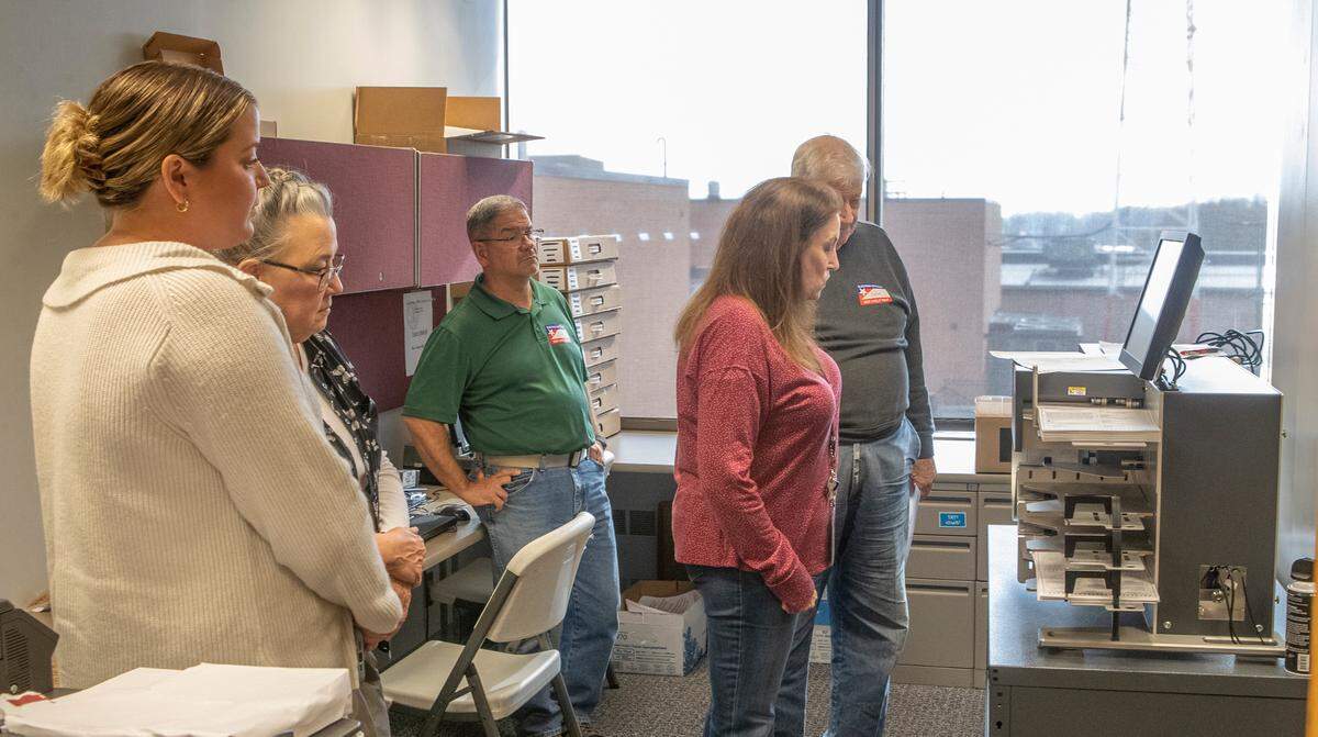 Democratic and Republican election judges and poll watchers process ballots at the St. Clair County Clerk’s office.