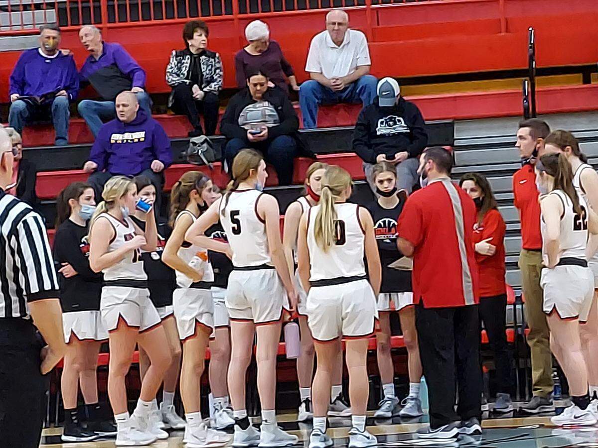 Highland coach Clint Hamilton discusses strategy with his players during a timeout in the second half of the consolation semifinals of the 35th annual Highland Tournament against Taylorville on Jan. 18, at Highland High School. The Lady Bulldogs coasted to a 51-36 triumph.