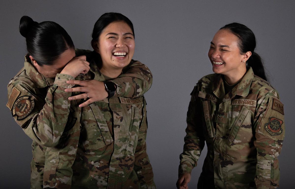 U.S. Air Force Airman 1st Class Angemie Paula Mendaza, 375th Operational Medical Readiness Squadron mental health technician; Airman 1st Class Ma Ann Geneli Dungca, 375th OMRS physical therapist; and Airman 1st Class Charlene Nulud, 375th Communications Support Squadron cyber systems operator, share a moment together on Scott Air Force Base. These Airmen enlisted in the Air Force after immigrating from the Philippines and have found friendship together.
