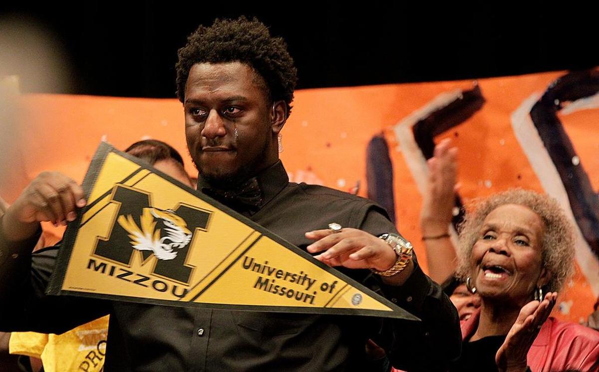 Tears stream down the face of East St. Louis’Terry Beckner Jr. after he declared his intention to play football for the University of Missouri last year. Now, Beckner has been suspended from the team.