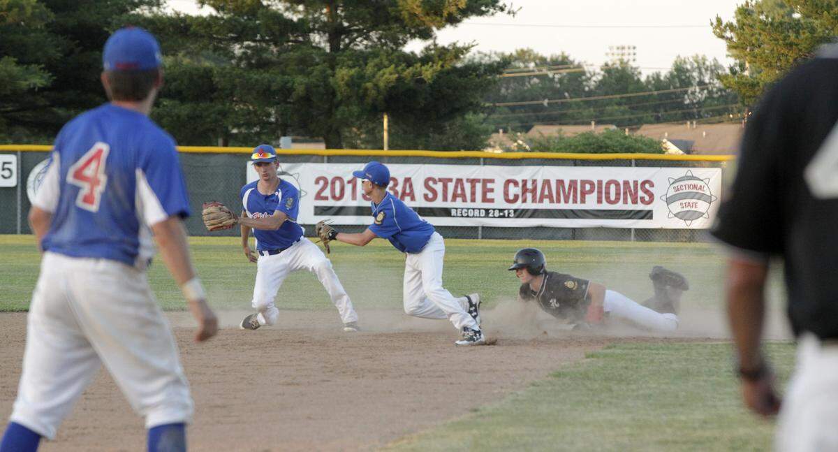 Jonathan Dickman dives into second base in Highland American Legion Post 439's first game of the season verses Belleville at Glik Park.