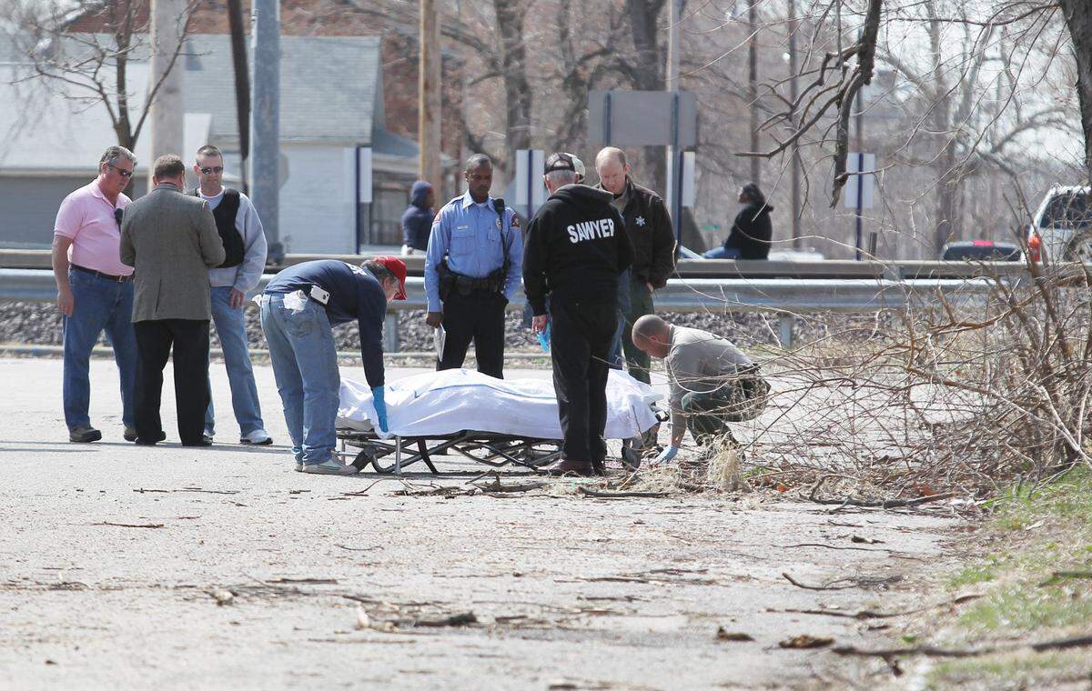 Workers with Sawyer ambulance remove the body from the crime scene. East St. Louis and Illinois State Police responded to a body found near the intersection St. Clair avenue and 7th St. in East St. Louis .