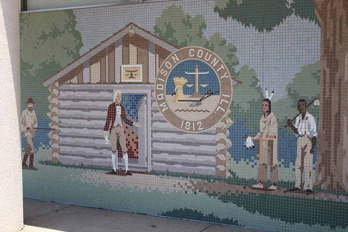 Today, the mural on the old Edwardsville City Hall shows a black farmer with a hoe slung over his shoulder.  Before 1988, he was a freed slave with an exaggerated smile, straw hat and ropes dangling from his wrists.