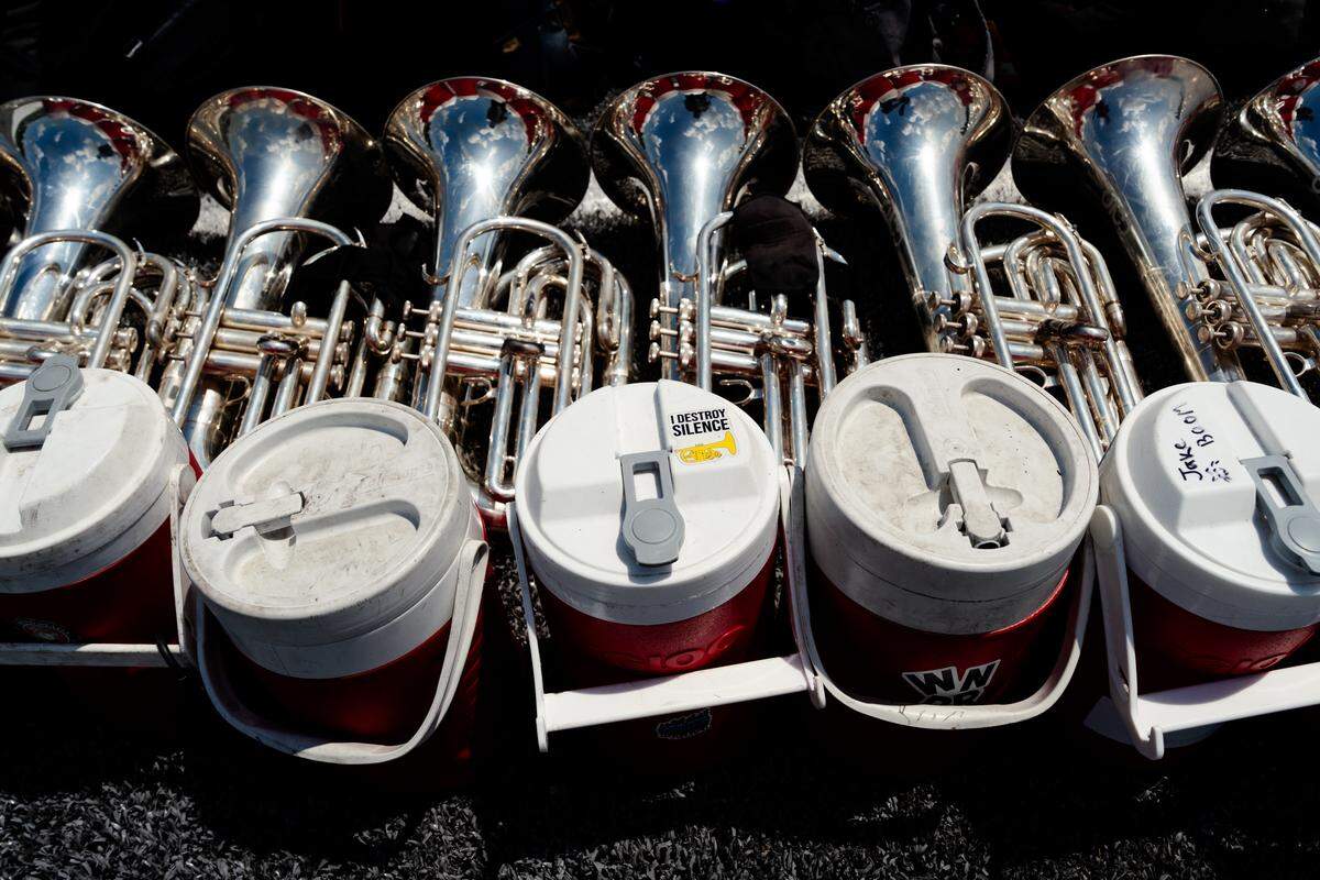 Euphoniums and baritones sit stacked beside matching red water jugs during a Boston Crusaders rehearsal on Tuesday, July 22, 2025, at Pattonville High School in Maryland Heights.