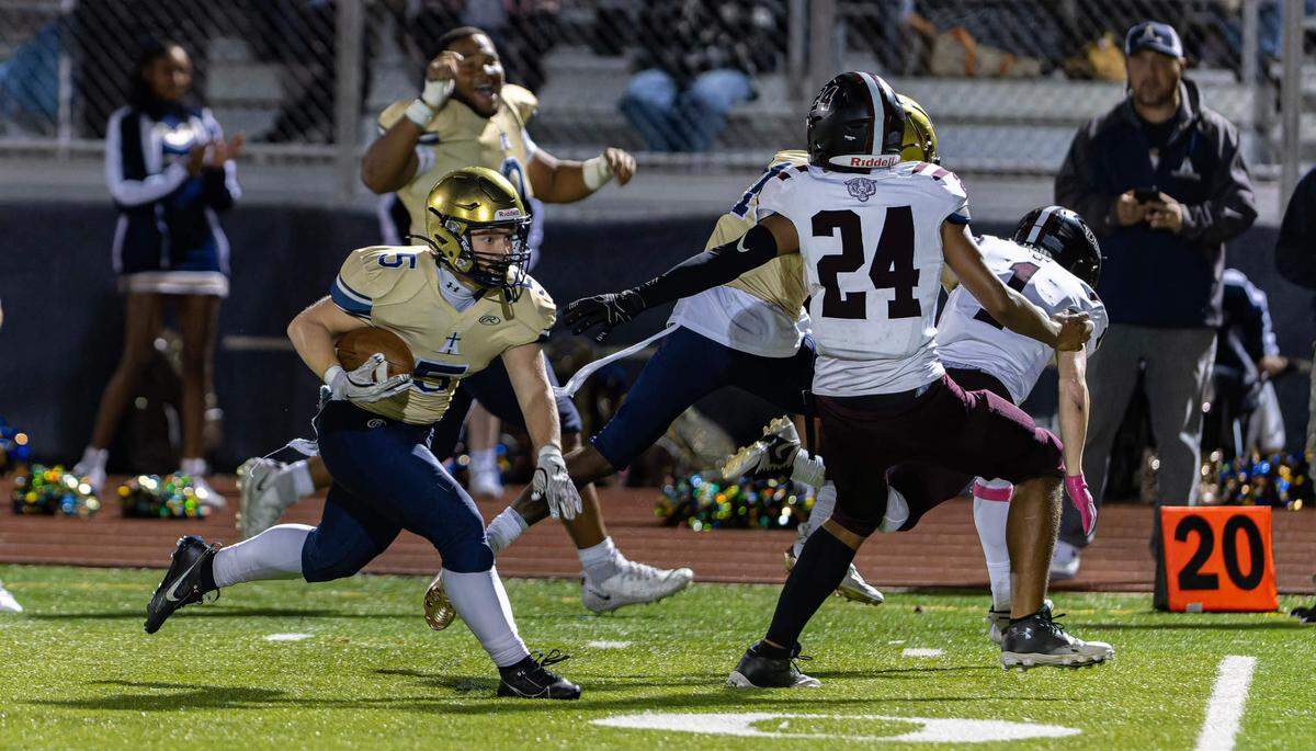 November 1, 2024 - Belleville IL, Althoff’s Lucas Jacquot (5) runs the ball for the first down during FridayÕs IHSA first round playoff games between Althoff Crusaders and Dupo Tigers [Photo: Jimmy Simmons]