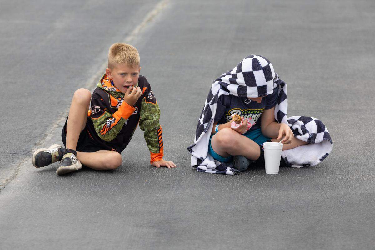 Fans enjoy food outside of the grandstands while a rain delay pushes back the start time for the NASCAR Truck Series race at the Enjoy Illinois 300 Cup Race at WorldWide Technology Raceway in Madison, Ill. on June 1, 2024.