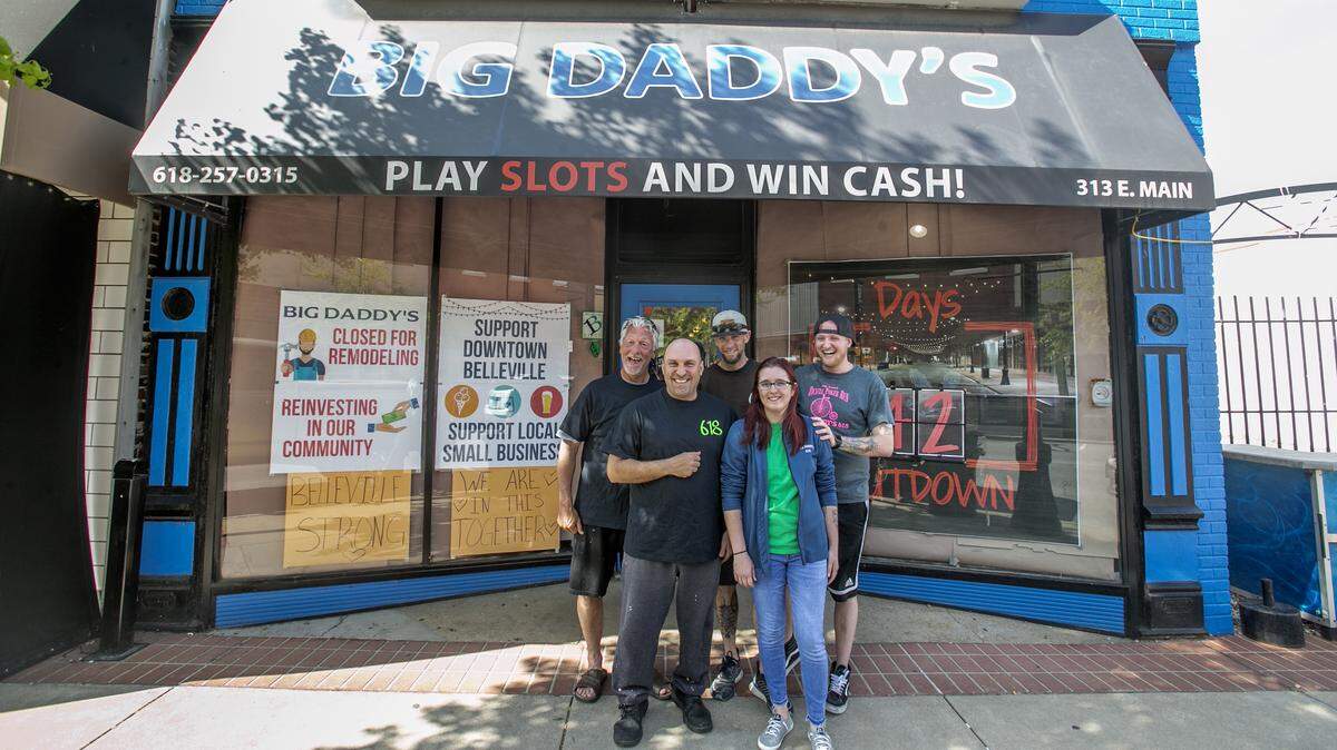 Scott Schmelzel, owner of Big Daddy’s 618 in Belleville, is surrounded by employees who helped with remodeling during the first coronavirus-related indoor-dining ban in Illinois last spring.