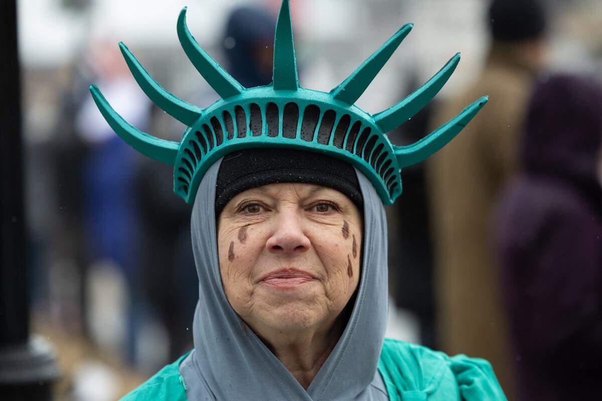 Lisa Cleveland attends a protest in Highland dressed in an outfit resembling a weeping Statue of Liberty.