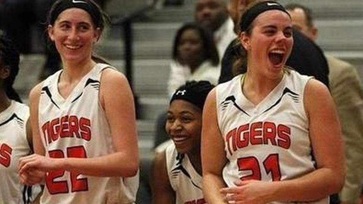 Edwardsville seniors Kate Martin and Rachel Pranger celebrate a Tigers victory last season.