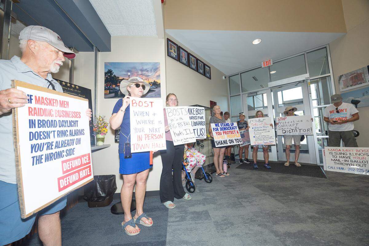 About a dozen protesters waited in the lobby of O’Fallon City Hall hoping to speak with U.S. Rep. Mike Bost, who was meeting with law enforcement.