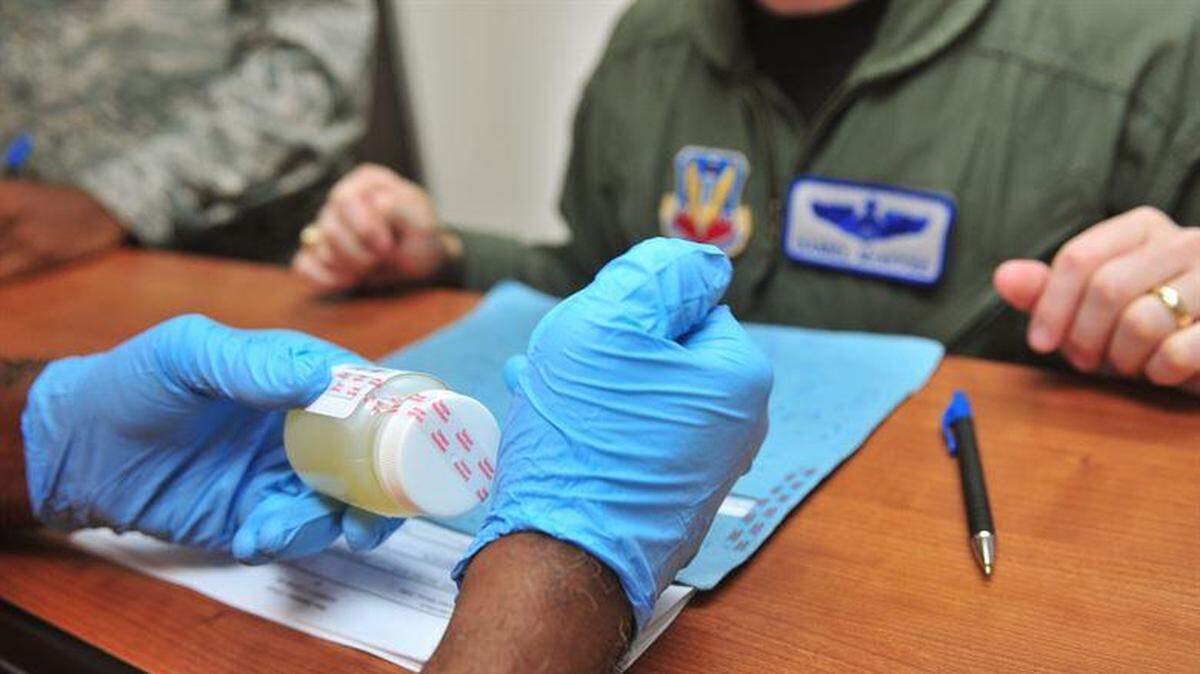 An Air Force member receives instructions on a drug test.