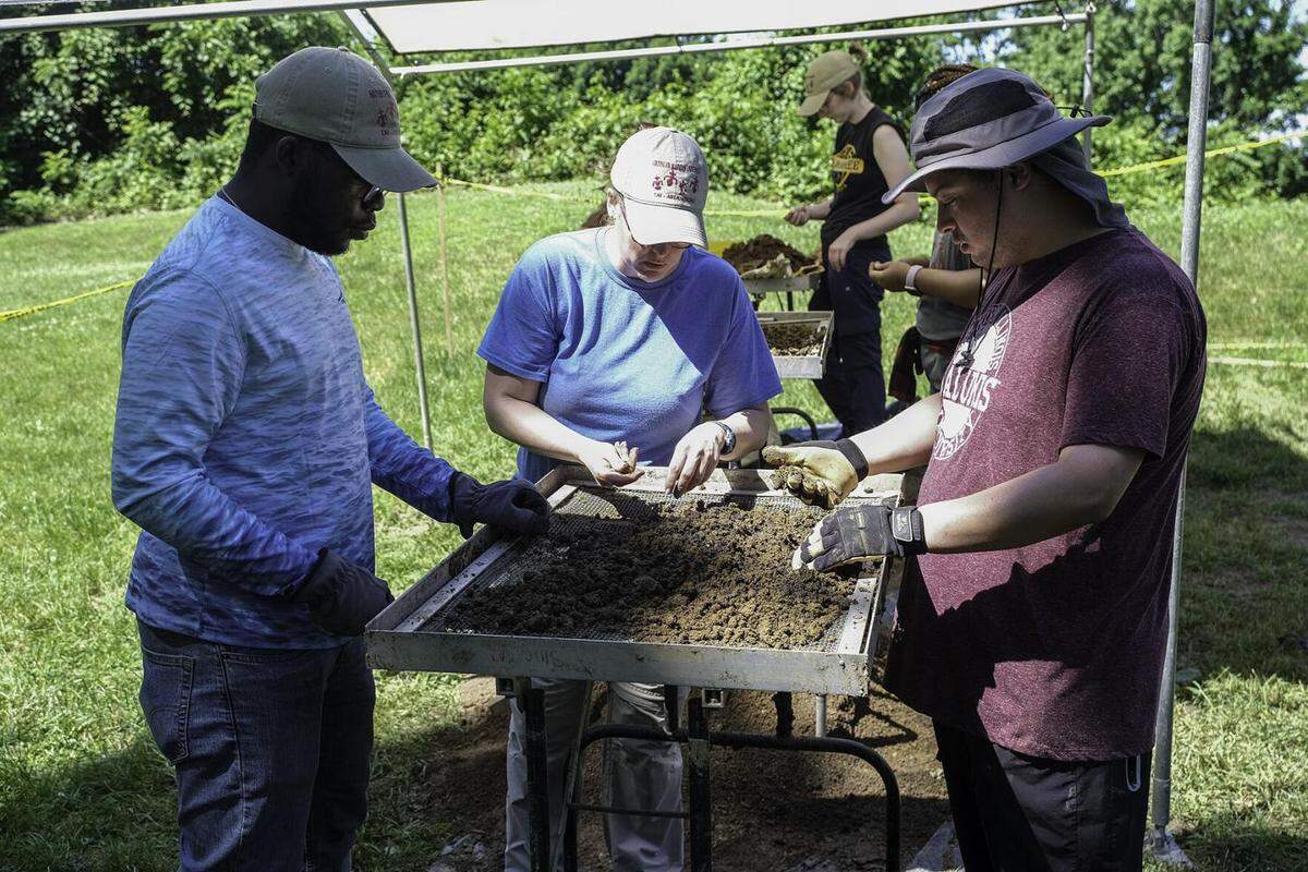 Researchers from the SIU Archaeology Field School sift through soil excavated from the site of a French fort at the Fort Kaskaskia State Historic Site near Ellis Grove.