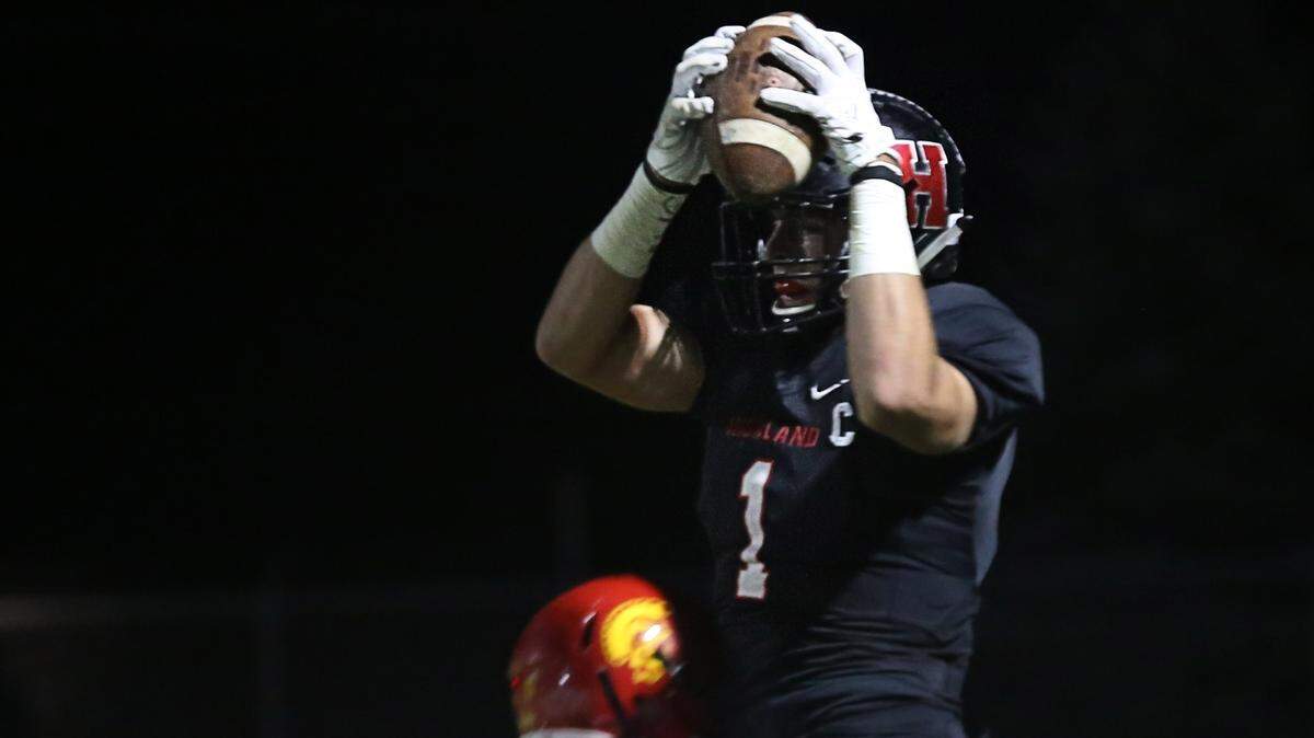 Highland senior Sam LaPorta goes high to haul in one of his three receptions against Charleston Friday night.