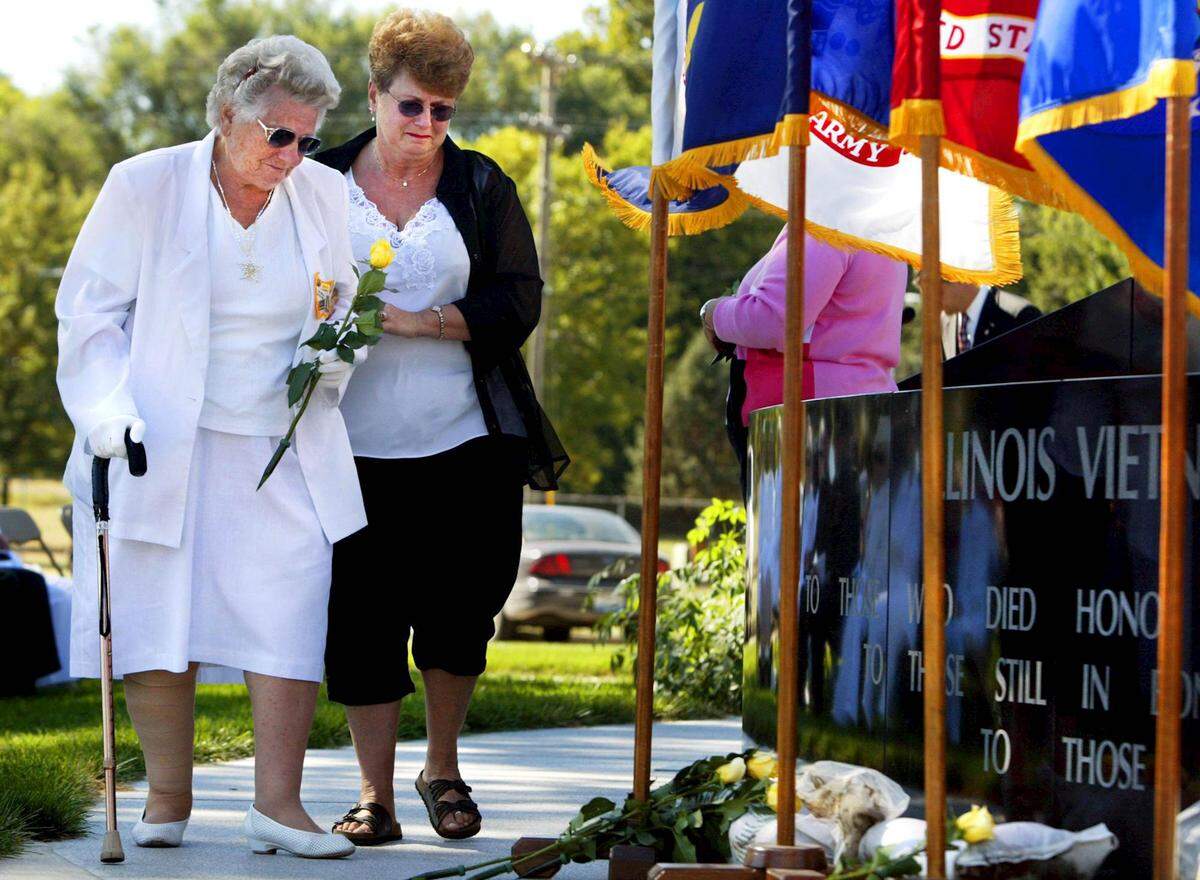 Dagmar Wiskow-Annable, right, from Worden, Illinois, helps her mother, Lieselotte Wiskow, left, walk toward the Illinois Vietnam Memorial so she can place a yellow rose in honor of her son, Ingo, a Green Beret, killed April 12, 1968, during a ceremony at Oak Ridge Cemetery in Springfield on Sept. 26, 2004. The Illinois Vietnam Veterans Memorial, dedicated in May 1988 in Oak Ridge Cemetery in Springfield, honors Illinoisans killed or listed as missing in action during the Vietnam War.