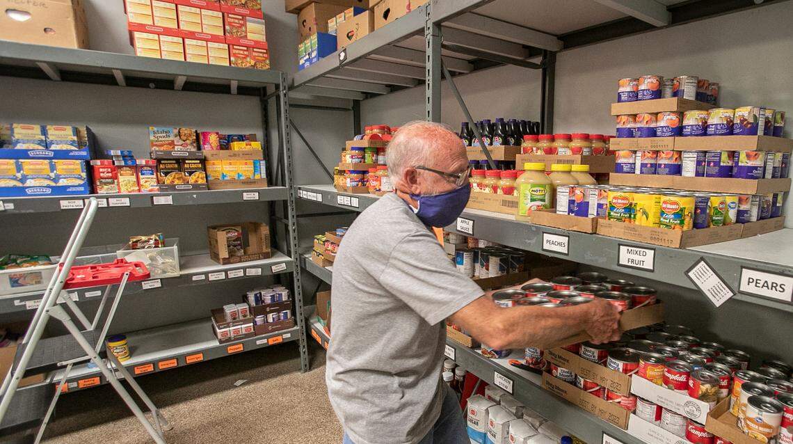 Volunteer Earl Haas restocks shelves Thursday before clients arrive at Community Interfaith Food Pantry at 1218 W. Main St. in Belleville.