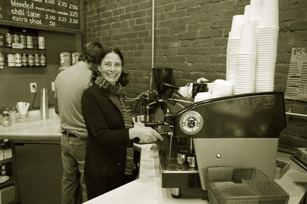 Jenn Courtney, the original owner of Sacred Grounds Café in Edwardsville, is shown behind the counter after getting a new espresso machine in 2018.