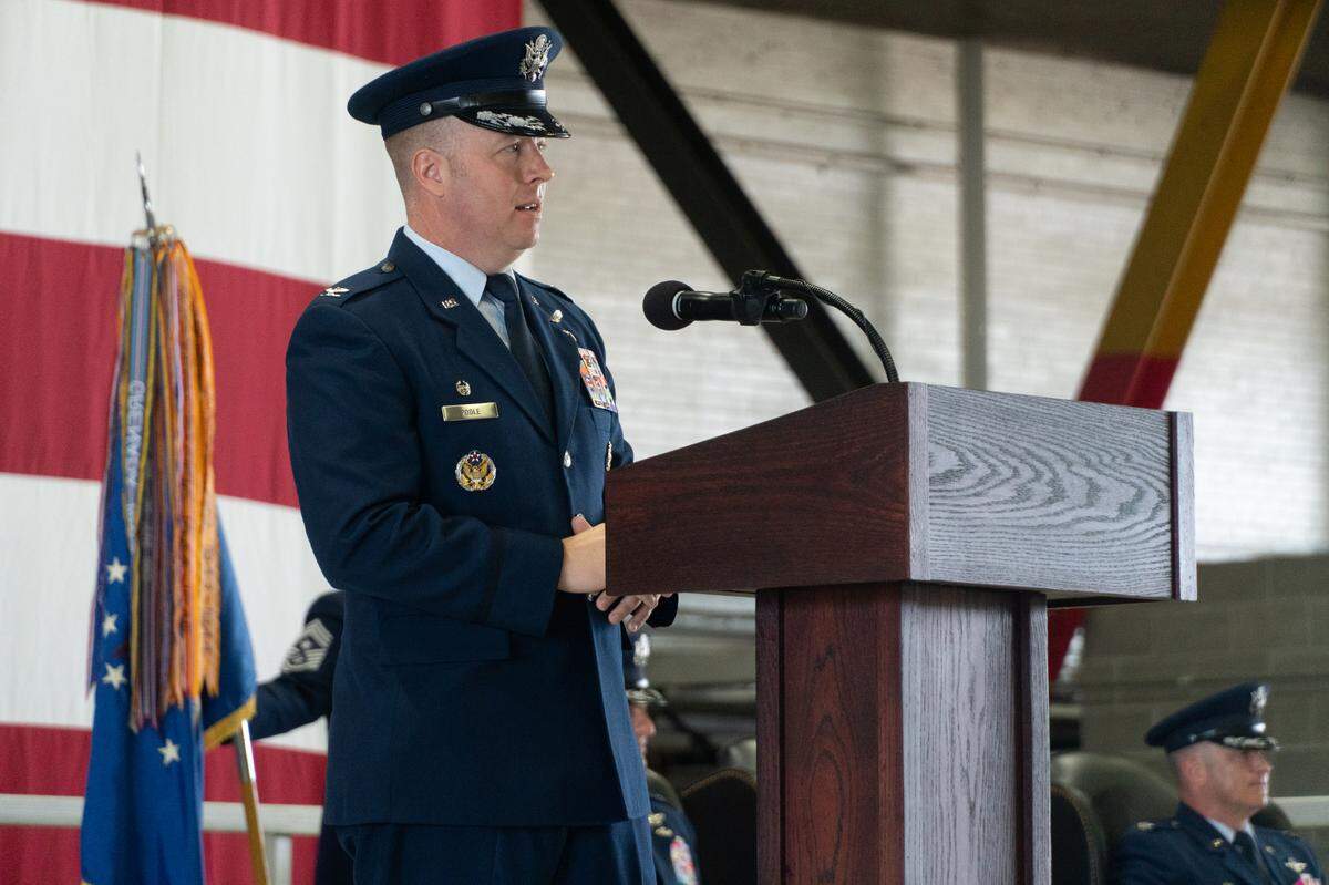 Standing in front of his predecessor, Col. John Poole speaks to a large crowd of airmen after being named the next commander of the 375th Air Mobility Wing, the wing that runs Scott Air Force Base.