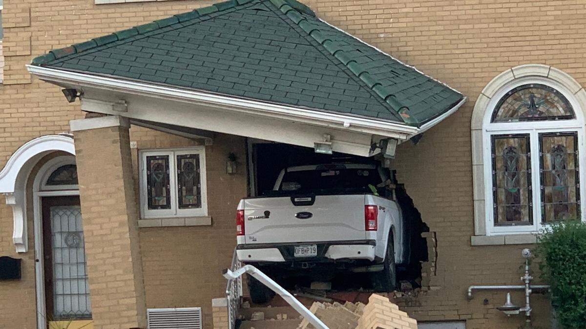 A white Ford truck that crashed into Kassly-Meridith Funeral Home in Collinsville early Sunday was still lodged in the building on Monday.