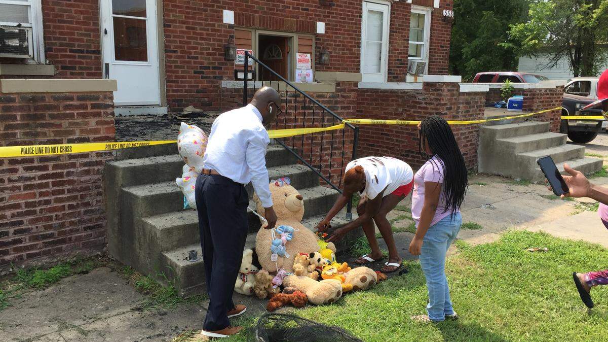 A large teddy bear, other smaller plush toys and a bouquet of balloons were placed in front of the apartment where five children suffered fatal injuries from a fire early Friday on North 29th Street in East St. Louis.
