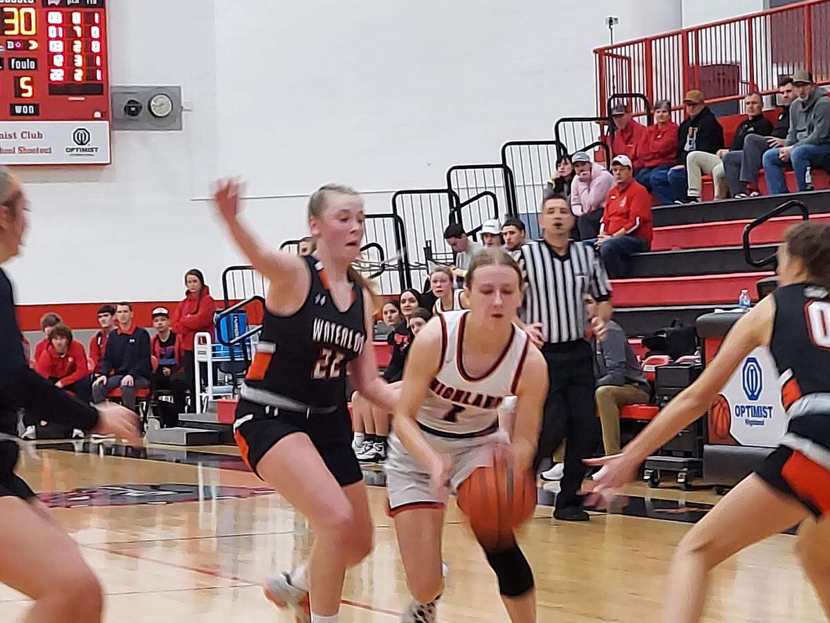 Highland guard Lauren Maas drives past Waterloo’s Aubrey Heck, 22, during the first game of the 31st annual Highland Optimist Scott Credit Union Shootout on Saturday, Jan. 7. Highland ultimately prevailed 54-52.