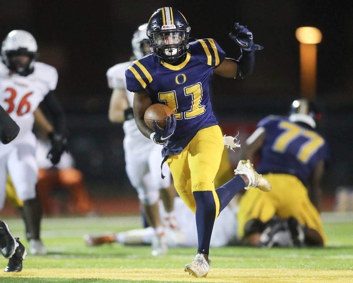 O’Fallon’s Christopher Caldwell carries the ball during an IHSA Class 8A playoff game against Edwardsville on Saturday night. The Panthers ultimately lost 43-36.