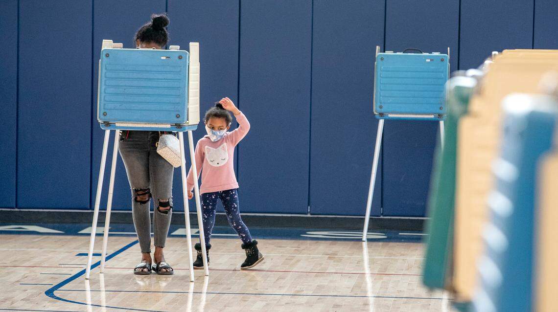 Gabrile Harlan, 4, dances while Florince Harlan, of Belleville, votes in the Presidential Election at the Abraham Lincoln Elementary school polling place in Belleville.