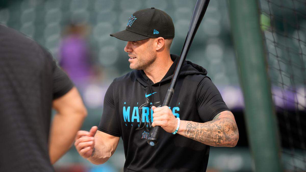 Miami Marlins manager Skip Schumaker hits ground balls to infielders as they warm up before a baseball game against the Colorado Rockies on Tuesday, May 23, 2023, in Denver. (AP Photo/David Zalubowski)