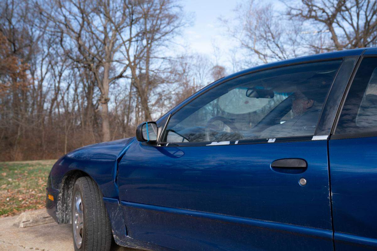 Gregory Harris, 70, sits in his car outside of the Maryville Heights apartment complex in Maryville, Ill., where a Dec. 20 fire in a nearby apartment drove him from his unit.