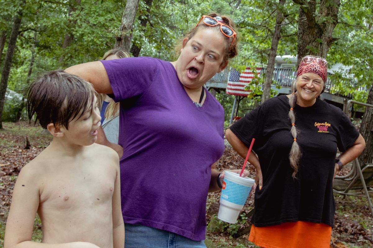 Tina Weber, far right, reacts as her daughter Samantha Bloodworth, 29, jokes around with her grandson Hayden Terrell, 10, on Saturday, July 27, 2024, while visiting Weber’s father’s home in Sullivan, Missouri.