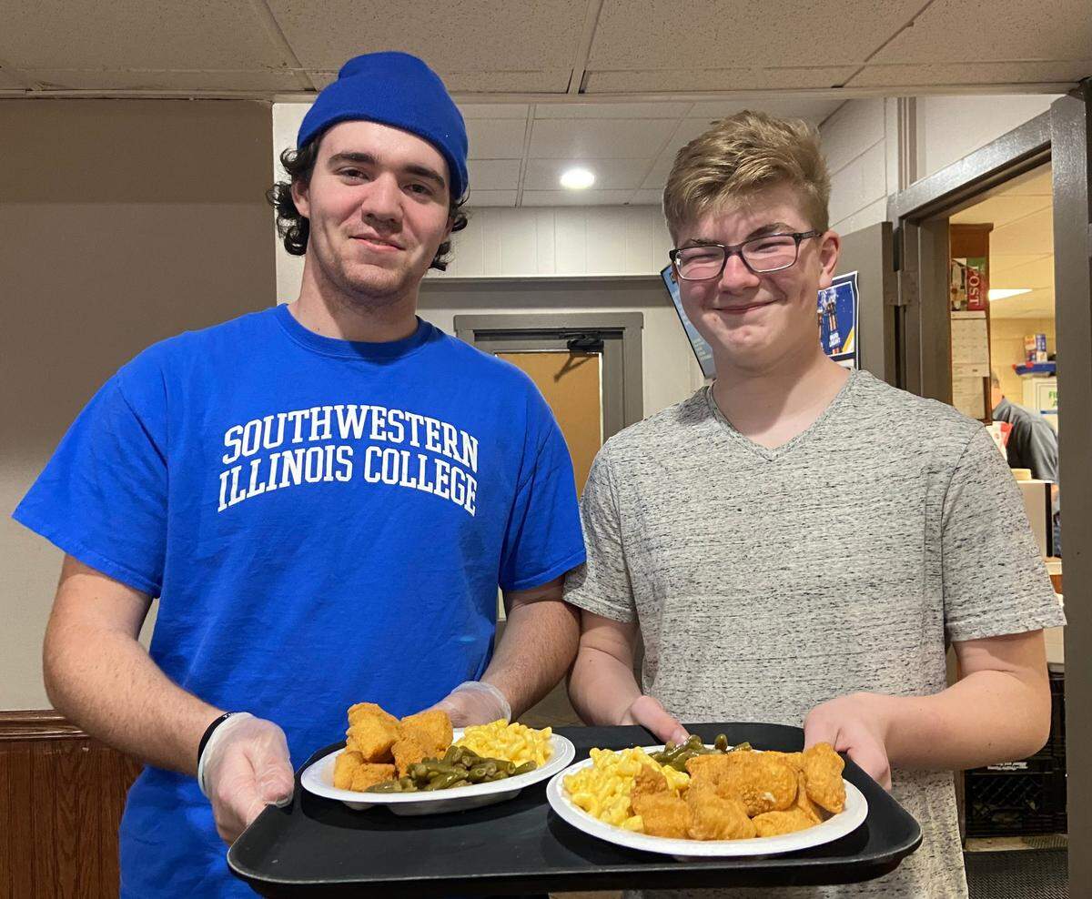 Jacob Cregger and John Hunt fill orders during the O’Fallon Knights of Columbus fish fry. The Knights of Columbus sponsors a fish fry every Friday during the year, with the operation kicking into high gear during the six weeks between Ash Wednesday and Easter Sunday for Lent.