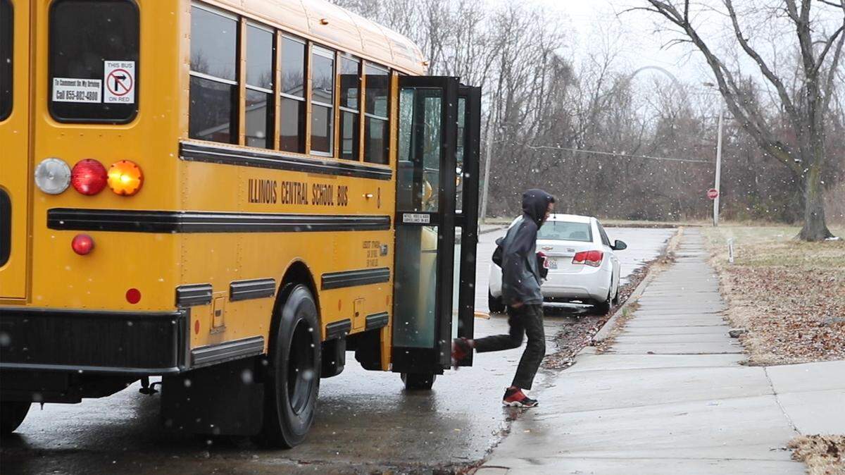A high school student steps off a bus in East St. Louis.