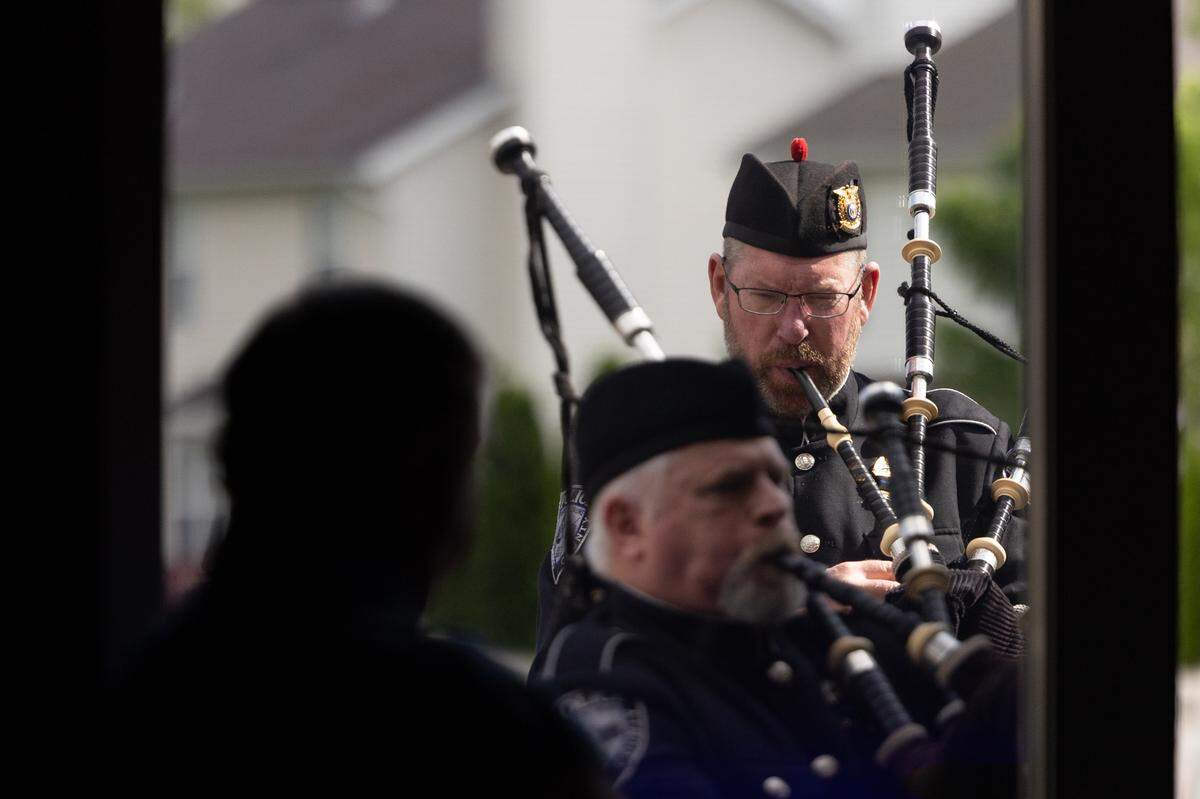 Pipers from St. Louis County Police Department Pipes & Drums perform “Amazing Grace” at the closing of a memorial service for fallen police officers of St. Clair County in Christ Church on Frank Scott Parkway in Fairview Heights, Ill. on May 7, 2024.
