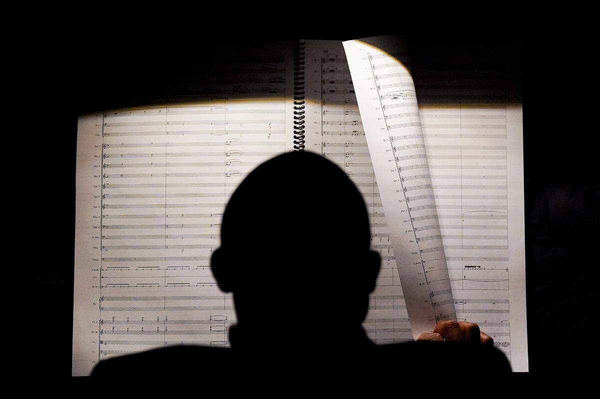 Baltimore-based composer James Lee III looks over a score as the St. Louis Symphonic Orchestra rehearses his piece to be premiered, “Visions of Cahokia,” on Wednesday, Jan. 25, 2023, at Powell Hall in Grand Center. 