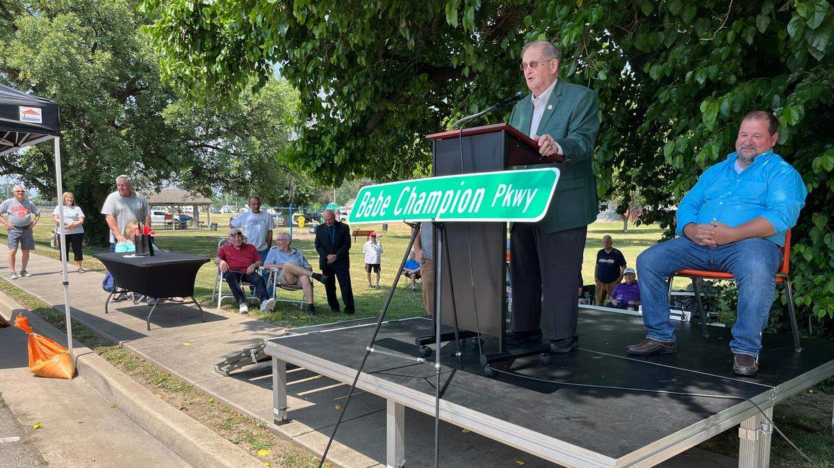Conrad “Babe” Champion speaks to Granite City supporters on Friday after Mayor Mike Parkinson, right, announced that he was naming a street after the community activist and retired teacher, coach and referee.