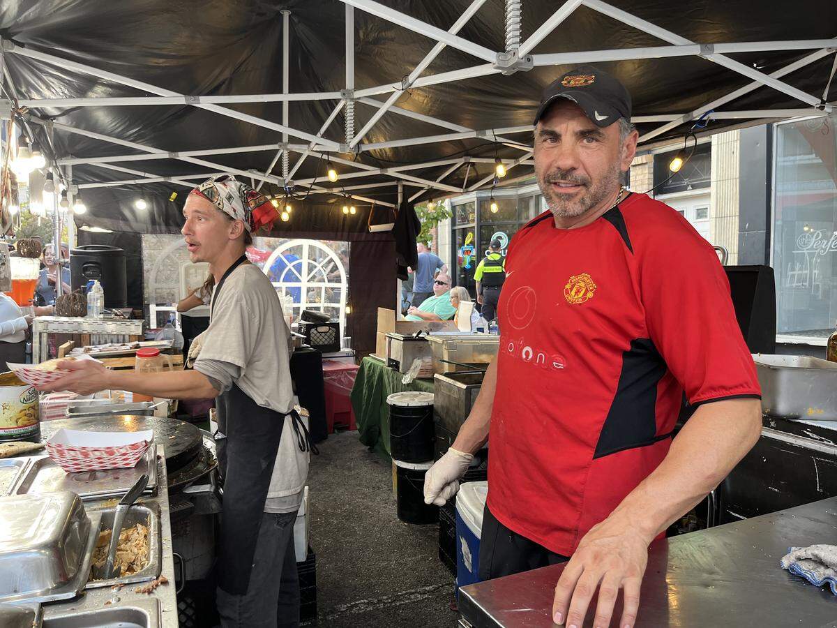 Teddy Tivanov, owner of Tivanov Catering Co. in St. Louis, right, and his staff won first place in the restaurant/caterer division of Belleville’s Chili Cook-Off contest on Saturday. In the background, employee Brandon Kett serves a quesadilla to a customer.