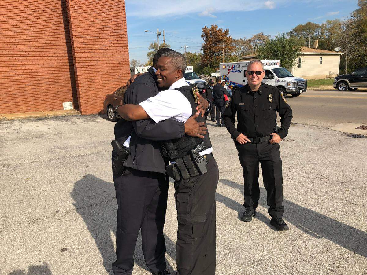Washington Park Chief Allen Bonds hugs Brooklyn Lt. Antonio White on Tuesday morning after police escorted Auxiliary Officer Ricardo Davis’ body from the St. Louis Medical Examiner’s Office to the Officer Funeral Home in East St. Louis. White and Davis were good friends.