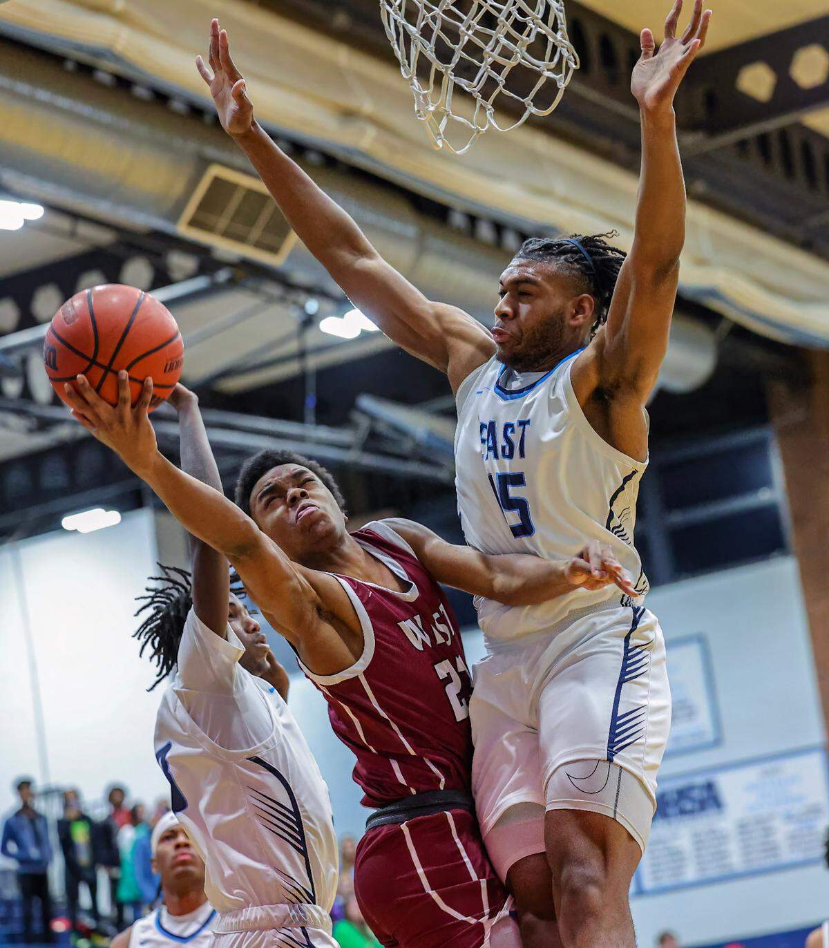 Belleville West’s Jordan Lacey shoots against Belleville East’s Alex Jackson during the Chick-fil-A Classic championship game. The Lancers ultimately prevailed 57-52.